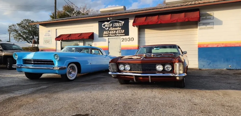 Blue classic car outside the Main Street Automotive shop