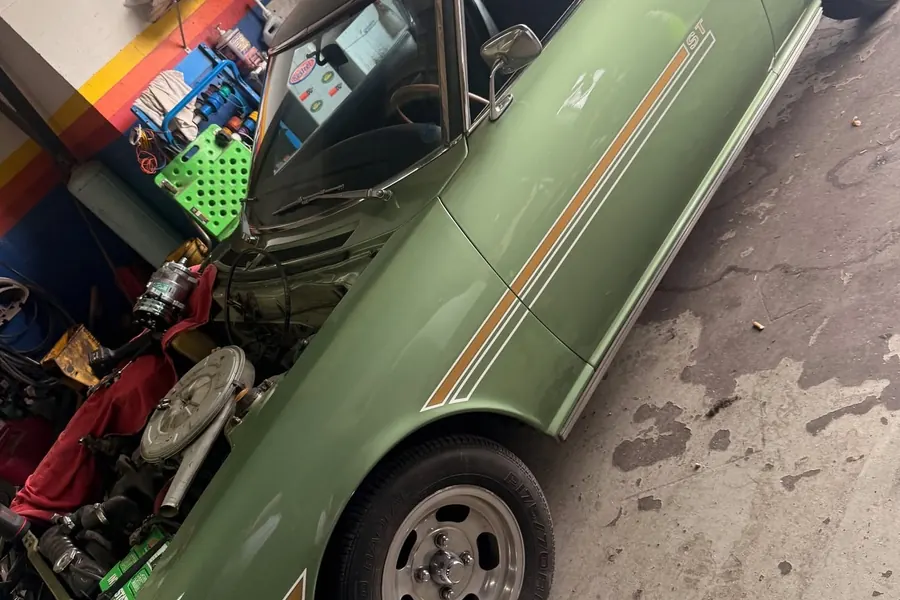 Green classic car in the workshop