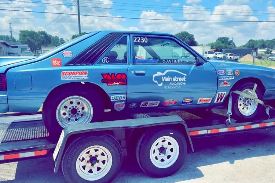 Blue race car loaded on a trailer