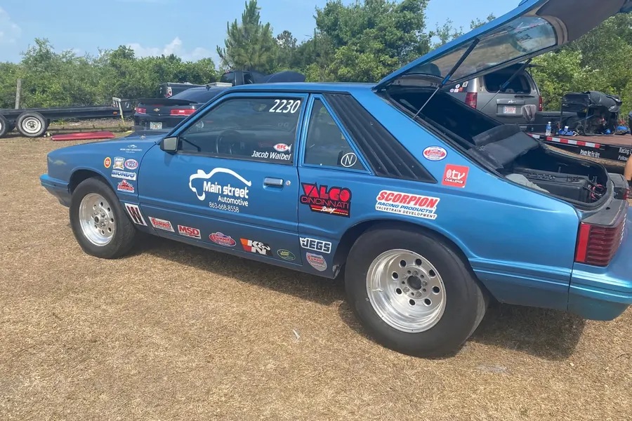 Blue race car with its hood open